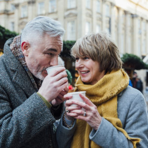 happy couple enjoying a coffee - concept: happy after agreeing a cohabitation agreement