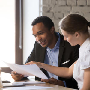 Woman giving male client financial advice