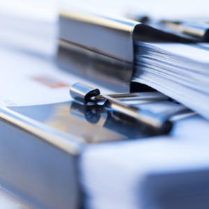 Piles of documents with black clip