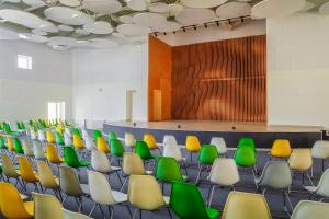 School assembly hall with stage for performance and rows of seats