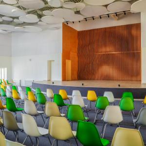 School assembly hall with stage for performance and rows of seats