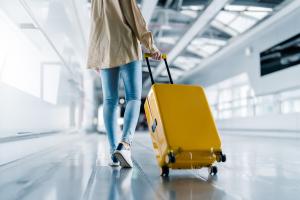 Woman with luggage walking in airport