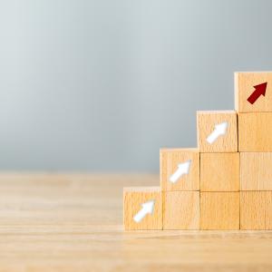 Wooden blocks with arrows stacked on top of each other as a concept to show processes