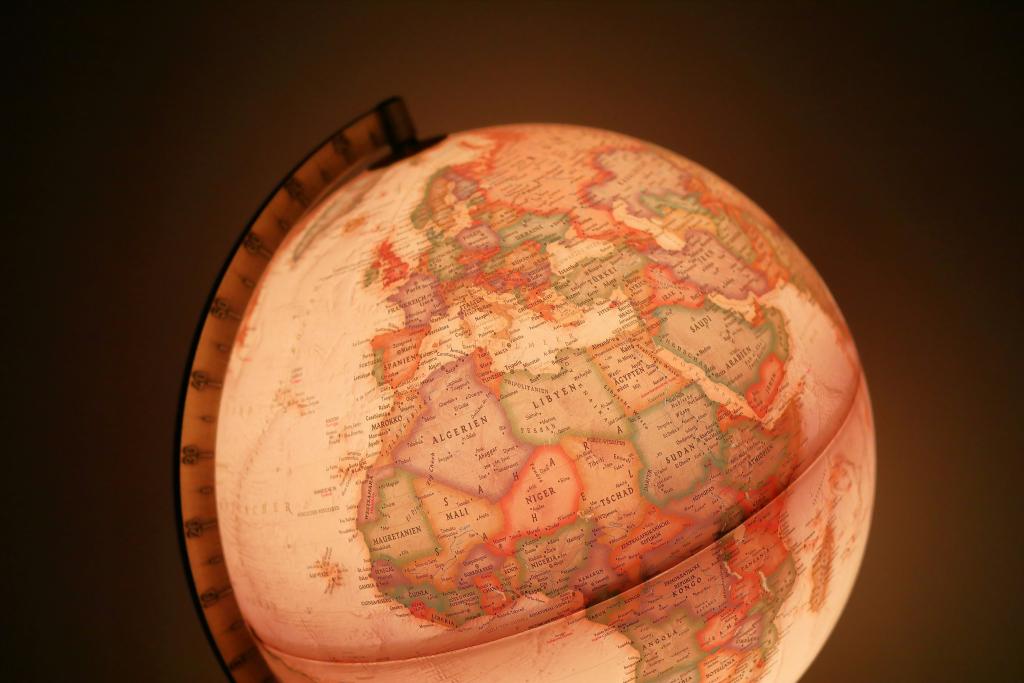 World globe ornament showing numerous countries and bathed in a warm light