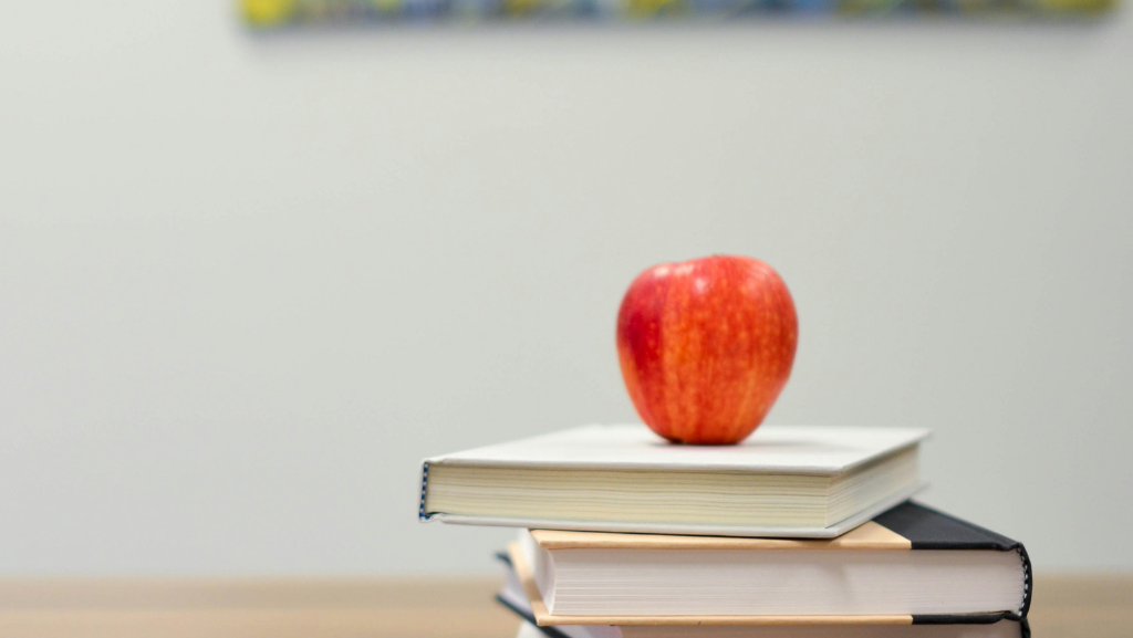 Apple on a stack of books suggesting return to school