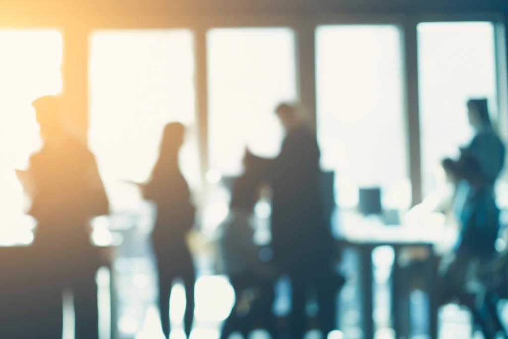 Blurred photograph of employees in an office