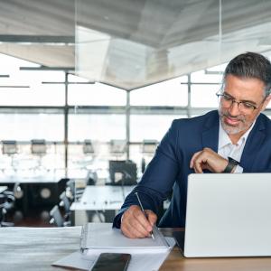 Middle aged smiling professional business man conducting a report on a business