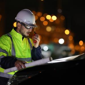 An electrical engineer working outside at night, as a concept for being a night worker