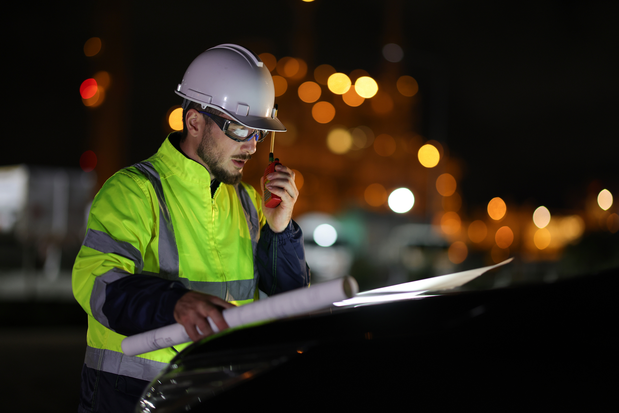 An electrical engineer working outside at night, as a concept for being a night worker