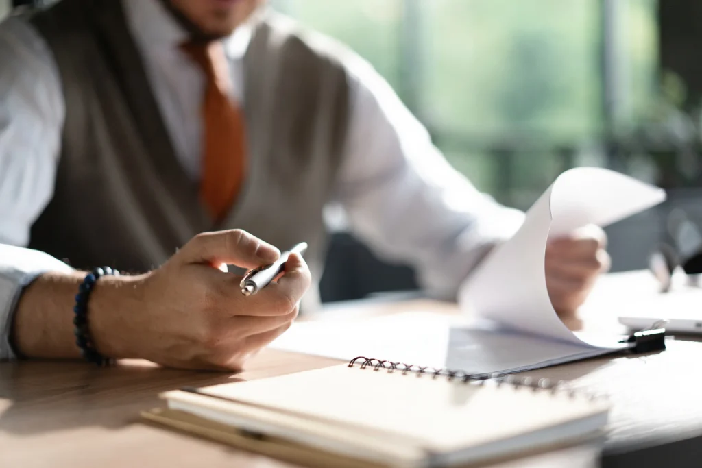 Business owner reviewing paperwork when planning to sell his business