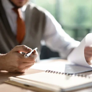 Business owner reviewing paperwork when planning to sell his business