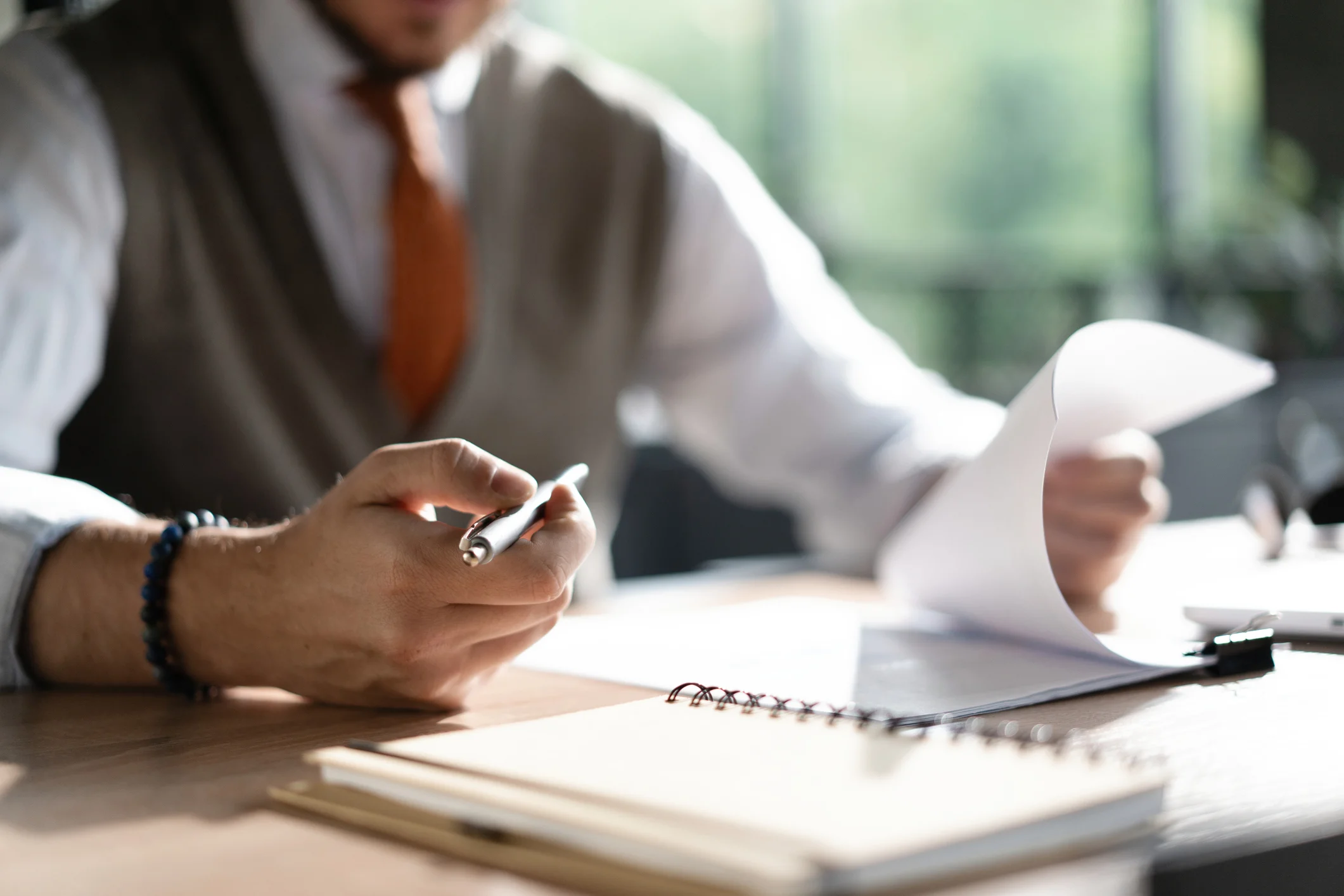 Business owner reviewing paperwork when planning to sell his business