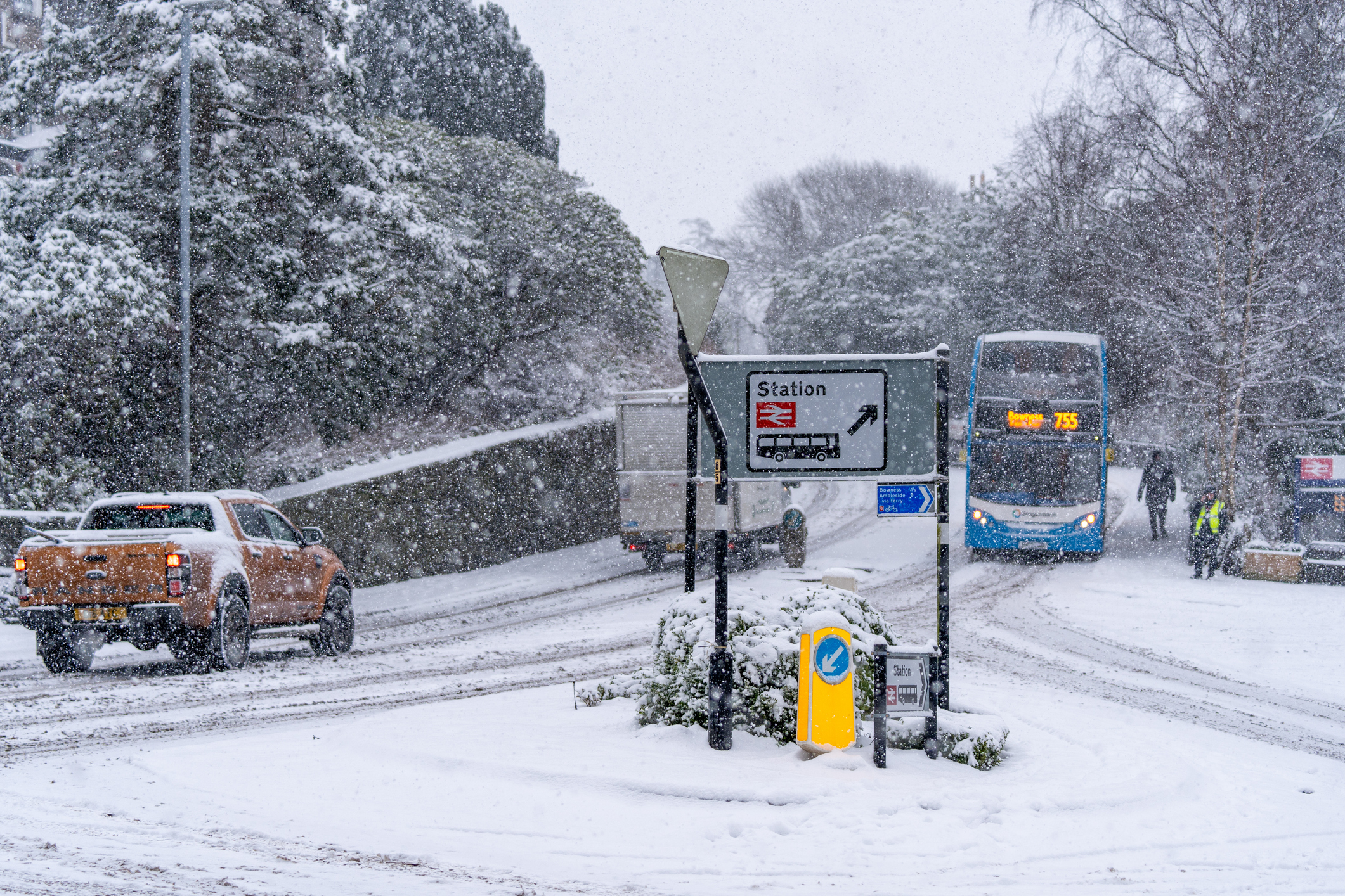 Vehicles driving on roads with heavy snow